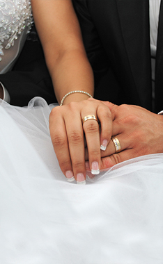 Bride and groom holding hands.