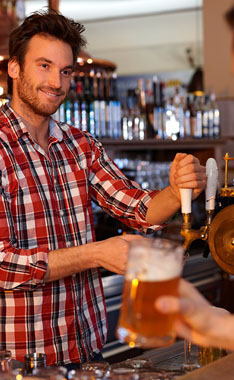 man pouring a beer